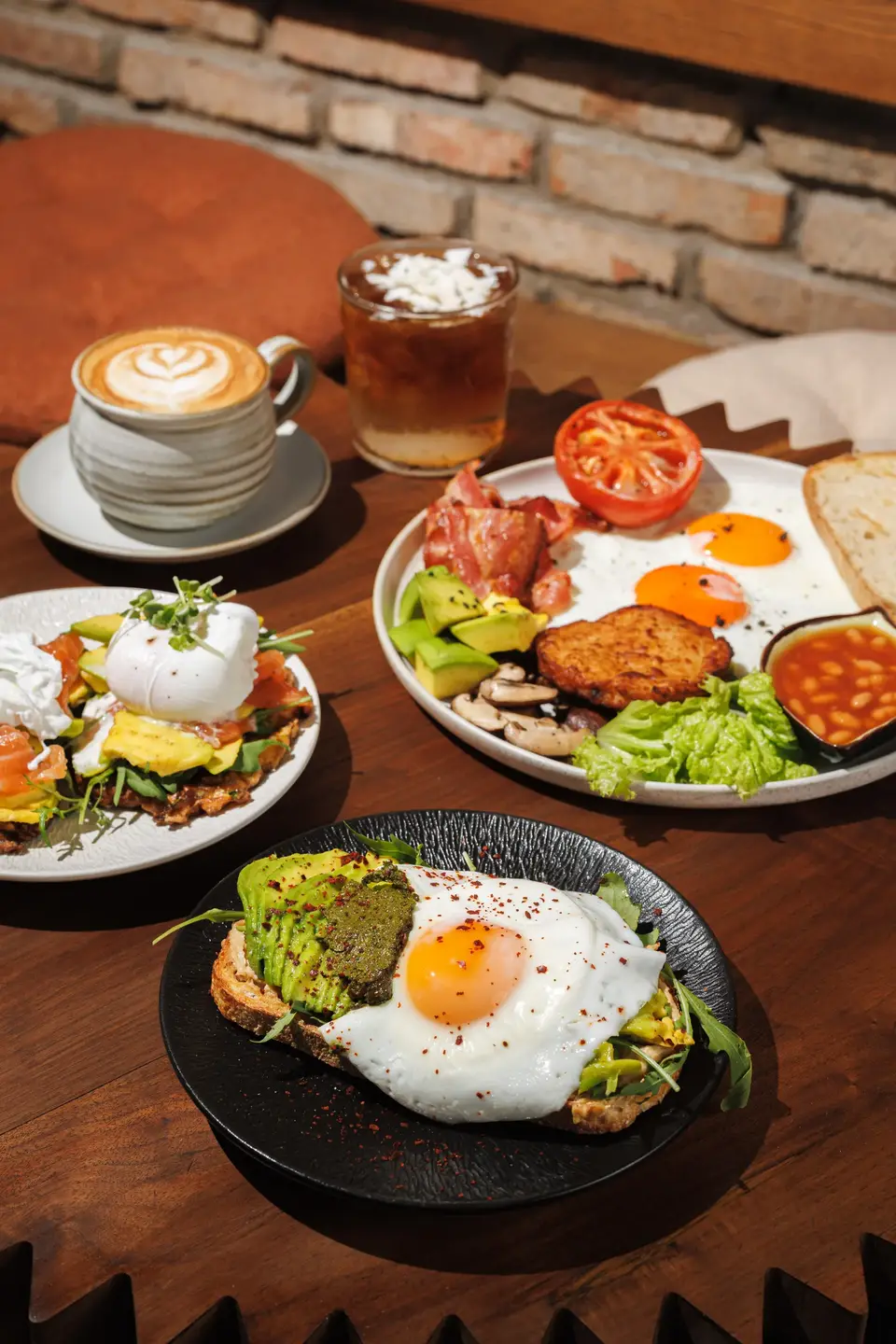 Breakfast plates with eggs and coffee on a round table